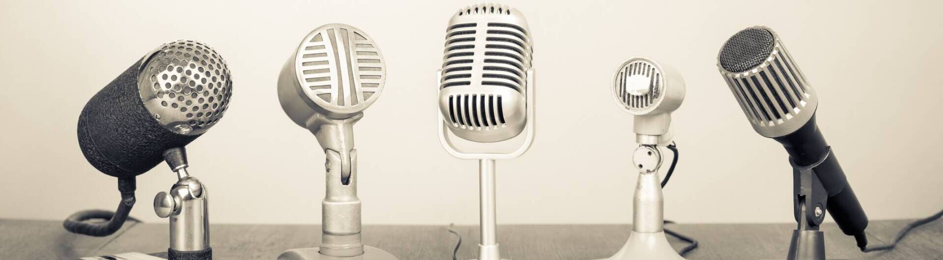 Close up of five silver microphones